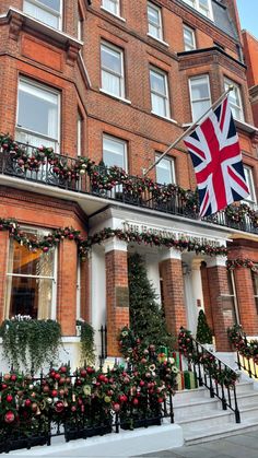 the british flag is hanging on the balcony of an apartment building in london, england