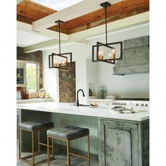 a kitchen with two stools next to an island and stove top oven in the center