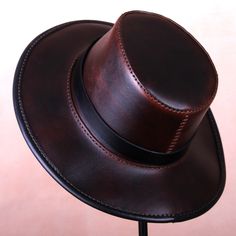 Leather Indiana Jones Fedora Hat Brown Fedora hat made of genuine leather. The style of the Hat is inspired by the adventures of Indiana Jones. A nice, practical hat for everyday use. Inside the edge binding is a stiff wire that can be formed by you to give the brim your own style. This hat is perfect for your outdoor adventures and western or steampunk style outfits. Indiana Jones Fedora, Steampunk Helmet, Leather Top Hat, Brown Fedora, Biker Helmets, Steampunk Hat, Leather Mask, Steampunk Style, Motorcycle Leather