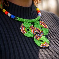 This handmade African necklace is the ultimate statement piece. Made with traditional Maasai beads, these bright and beautiful pieces will add the perfect finishing touch to any outfit. The clasp is made of brass and is a simple, comfortable design.  Made by women from the Maasai community in Kajiado County, Kenya.  These are traditionally worn by individuals of any gender. In East Africa, every beaded ornament we adorn tells a story and we're proud to tell our stories about our culture. We also embrace and appreciate individuals from other cultures who share in our love for these beautiful and brightly beaded pieces! Necklace African, African Necklace, Handmade African, Comfortable Design, Maasai, Jewelry Statement, African Jewelry, Beaded Ornaments, East Africa