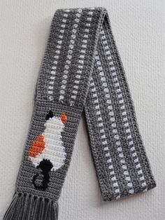 a gray scarf with an orange and white cat on it