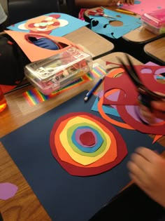 a person cutting out paper shapes on a table