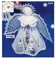 a crocheted angel ornament with snowflakes and ornaments around it