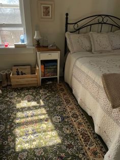 a bed room with a neatly made bed and a rug on the floor next to it