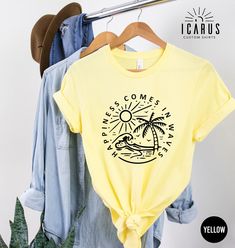 Happiness Comes In Waves Shirt, Positive Gift for Women, Summer Vibes Tee, Beach Vacation Top, Inspirational Sun T-Shirt, Family Trip Shirt Welcome to Icarus Custom Shirts ( https://www.etsy.com/shop/IcarusCustomShirts ), our online haven of artistic expression. Discover a world of trendy and custom designs, made just for you, to express your unique style. From funny quotes to artistic creations, browse through our diverse collection, find the perfect design to make a statement and let your pers Printed Yellow T-shirt For Vacation, Yellow Printed T-shirt For Vacation, Yellow Summer Shirt For Beach Season, Summer Yellow Shirt For Beach Season, Yellow Graphic Print Vacation Shirt, Yellow Graphic Print Top For Beach Season, Yellow Graphic Print Shirt For Vacation, Yellow Crew Neck Beach T-shirt, Yellow Crew Neck Top For Beach Season