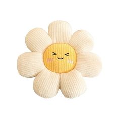 a white flower with a yellow face on it's head and one eye closed