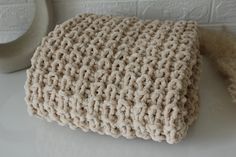 a crocheted pillow sitting on top of a white table