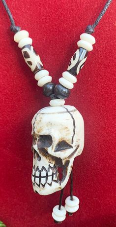 Skull pendant Necklace with adjustable black cord. Handmade in Nepal from Yak bone. The adjustable necklace can be extended to 28 inches or shortened to 14 inches. Unique Adjustable Bone-colored Necklace, Unique Adjustable Bone Necklace, Unique Adjustable Bone Colored Necklace, Adjustable Skull Necklace For Festivals, Bone Color Bohemian Adjustable Necklace, Adjustable Bone-colored Jewelry For Festival, Adjustable Bone Color Jewelry For Festival, Adjustable Bone-colored Jewelry For Festivals, Skull Pendant Necklace