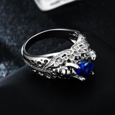 Tired of rings without any style? discover Blue Sapphire Skull Ring with a novel design and premium quality to provide you with the appeal you desire, dare to feel the difference. White Gold Skull Jewelry For Promise Ring, Luxury Silver Skull Ring For Anniversary, Luxury Skull Ring As Gift, Luxury White Gold Skull Ring Gift, Elegant White Gold Skull Ring For Promise, Classic Skull Ring Gift, Elegant Skull Ring For Anniversary, Luxury Skull Ring For Gift, Elegant White Gold Skull Promise Ring