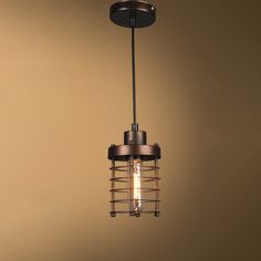 a light that is hanging from the ceiling with a cage on it's side