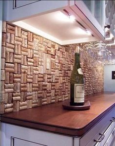 a bottle of wine sitting on top of a wooden counter