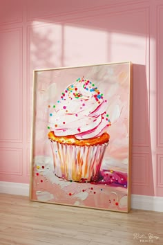 a painting of a cupcake with sprinkles on it in front of a pink wall