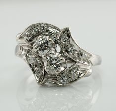 Genuine Diamond Ring, April Birthstone, Vintage Ring, 14K White Gold Ring, Statement Ring, Floral Ring, Elegant Ring, 1950s Ring. This vintage ring is made in solid 14K White Gold. Two center old European cut diamonds total .33 carats (.18ct + .15ct) of VS2-SI1 clarity and H color. 10 single cut diamonds total .20 carat of VS2 clarity and H color. The total diamond weight for the ring is .53 carat. The top of the ring measures 13mm North-South. Size 6.5 (sizable). The ring weighs 4.4 grams. Grea Vintage Three Stone Platinum Jewelry, Vintage Platinum Three-stone Jewelry, Vintage Three-stone Platinum Jewelry, Estate Oval Diamond Rings, Estate Platinum Rings With Center Stone, Estate Platinum Rings, Estate Diamond Cut Diamond Rings, Estate Style Diamond Cut Diamond Rings, Art Deco Diamond Cluster Ring With 17 Jewels