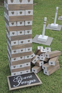 several wooden blocks stacked on top of each other in front of a chalkboard sign