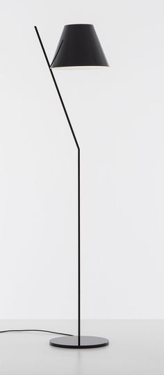 a black floor lamp on a white table