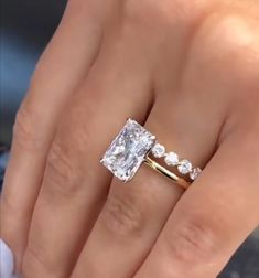 a woman's hand with a ring on it and a diamond in the middle