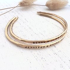 "This rustic brass bangle is made from 10 gauge solid brass wire. Hand Forged into a bangle, then personalized with your words. The brass bangle has an organic look to it. H A N D-S T A M P I N G-P R O C E S S *All personalization is done by hand Hand stamping is a process where each letter is individually stamped into the metal. Each letter may not line up perfectly and some letters may be deeper than the others. Although I do try my best to make sure each letter is as straight as possible. Thi Gold Name Cuff Bracelet Bangle, Gold Cuff Bracelet With Name Bangle, Custom Name Gold Bangle, Adjustable Engraved Brass Bangle, Custom Name Cuff Bangle For Anniversary, Custom Name Cuff Bracelet Bangle For Anniversary, Custom Name Bangle Cuff Bracelet For Anniversary, Custom Name Cuff Bracelet For Anniversary, Adjustable Stamped Gold Cuff Bracelet