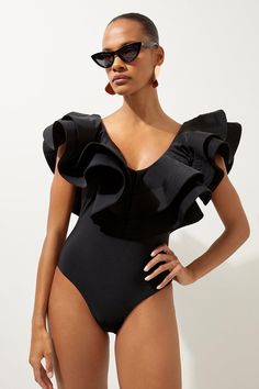 Drama Frill Swimsuit | Karen Millen V-neck One-piece With Ruffles For Poolside, Chic V-neck Bodysuit For Sunbathing, Chic Ruffled Bodysuit For Beach Season, Fitted Ruffles Bodysuit For Pool, Fitted Ruffled Bodysuit For Pool, Elegant Bodysuit For Sunbathing Beach Season, Chic Ruffled Bodysuit For Vacation, Summer Ruffled V-neck Bodysuit, Summer V-neck Ruffled Bodysuit