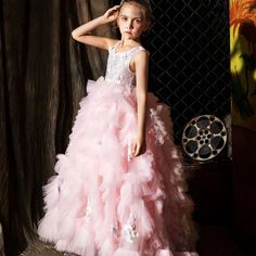 Indulge your little girl's royalty with our Dreamy Vow Pink Luxury Dubai Kids Girl Dress. This stunning ball gown features intricate Arabic appliques and tiered layers, perfect for weddings, parties, birthdays, or pageants. Give her the spotlight she deserves with this princess-worthy dress. Princess Style First Communion Dress With Ruffles, Princess Ball Gown First Communion Dress With Ruffles, Princess Style Ball Gown First Communion Dress With Ruffles, Pink Princess Ball Gown For First Communion, Quinceanera Tulle Pageant Dress With Ruffles, Quinceanera Pageant Ball Gown With Ruffles, Prom Season Princess Dress With Ruffles, Prom Season Princess Ball Gown With Ruffles, Tulle Ruffle Pageant Dress For Prom Season