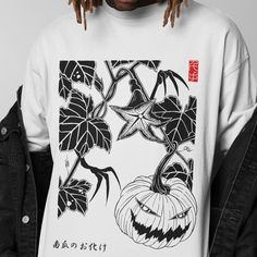 The Halloween pumpkin Tshirt features a spooky streetwear design with a Japanese graphic, perfect for fall events. This oversized unisex T shirt combines festive style with comfort. 𝗗𝗘𝗧𝗔𝗜𝗟𝗦 - Side seams for structural support - Ribbed knit collar for shape retention - Shoulder tape for stability - Made with 100% lightweight cotton for breathability - Retail fit for casual and semi-formal settings 𝗖𝗔𝗥𝗘 𝗜𝗡𝗦𝗧𝗥𝗨𝗖𝗧𝗜𝗢𝗡𝗦 - Machine wash: cold (max 30C or 90F) - Non-chlorine: bleac Urban Halloween T-shirt For Streetwear, White Tops With Anime Print For Halloween, Harajuku Graphic Print T-shirt For Fall, White Anime Print Top For Halloween, Urban Graphic Design T-shirt For Fall, Harajuku Style Cotton T-shirt For Fall, Harajuku Style Halloween Graphic Print Tops, Halloween Anime Print Grunge T-shirt, Anime Print Halloween Streetwear Tops