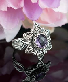 Amethyst Silver Victorian Lotus Flower Ring, 925 Sterling Artisan Handmade Filigree Floral Purple Cocktail Ring, Women Statement Ring Purple stone ring, vintage ring gift, Anniversary gift, floral wedding gift, silver boho jewelry, handmade lotus ring Material: 925 Sterling Silver ( NICKEL FREE ) Gemstone: Amethyst 8 mm. -The stone used in this jewelry, Amethyst Gemstone, is the February Birthstone. FREE, FAST AND TRACKABLE SHIPPING FOR ALL EU COUNTRIES AND USA. Amethyst has been thought to have many attributes throughout history, and all of them are good. The stone was thought to control evil thoughts, quicken intelligence, make a shrewd man in business, preserve soldiers from battle wounds. According to Greek mythology, Amethyst was a young virgin who became the object of wrath of the Gr Evil Eye Stone, Evil Thoughts, Purple Cocktails, Silver Boho Jewelry, Lotus Flower Ring, Purple Stone Rings, Lotus Ring, The Ring Face, Flower Women