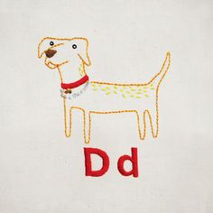 the embroidered dog is standing in front of the letter d