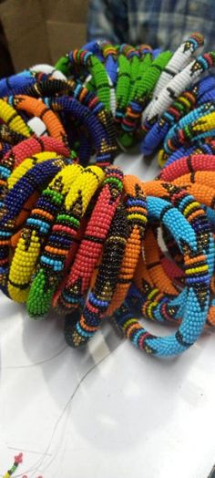 100 bracelets with different colour patterns. Multicolor Bohemian Bracelets For Festivals, Bohemian Multicolor Bracelets For Festivals, Multicolor Bohemian Bracelet For Festivals, Multicolor Bohemian Beaded Bracelets For Festivals, Bohemian Multicolor Beaded Bracelets For Festivals, Colorful Festival Bracelets, Multicolor Beaded Bangle For Festival, Multicolor Bangle With Colorful Beads For Festival, Multicolor Hand Wrapped Beaded Bracelets For Festival