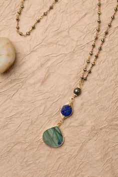 Discover the vibrant and stunning colors of the Blue Moon Collection in this eclectic necklace! Gold Filled (Lead & Nickel Free) Pyrite, Lapis Lazuli, Labradorite 30" We hand select our natural materials, thus there may be slight variations in color and/or size that will not detract from the overall aesthetic. Our unique handcrafted designer jewelry for women is made in America, each design created individually in our personal design studio in Floyd, VA USA Artisan Blue Labradorite Necklace, Bohemian Blue Labradorite Necklace, Eclectic Necklace, Silver Gold Earrings, Silver Gold Necklace, Pyrite Necklace, Cluster Necklace, Gold Collection, Beaded Jewelry Patterns