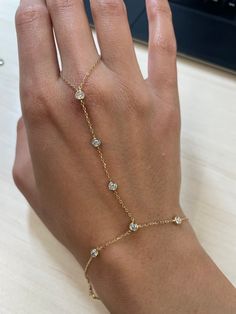 Are you looking to add a little something extra to your wrist stack? This Diamond by the inch hand harness is calling your name! Still dainty and delicate, but as your hand moves this piece will be sure to sparkle! Available in 18k Yellow Gold, Rose Gold and White Gold Total Diamond Carat Weight: .6cts Diamond Color: G Diamond Clarity: SI1 Made to order. Lead time is 2-4 weeks Benefits of 18k Solid Gold Jewelry Most loved for its durability and longevity Can be worn daily and requires less maint Rose Gold And Gold Jewelry, Ring With Bracelet Attached, Cool Piercing Ideas, Jewelry Inspo Gold, Cute Bracelet Ideas, Cool Piercing, Dainty Jewelry Bracelets, Gold Snake Jewelry, Finger Ring Bracelet