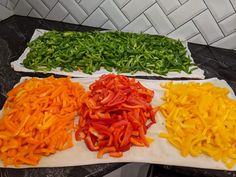 several different types of peppers on a counter top next to each other, all cut up and ready to be cooked