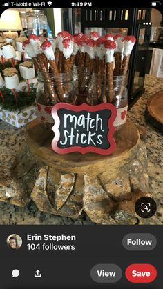 a bunch of pretzels sitting on top of a wooden stand with a sign that says match sticks