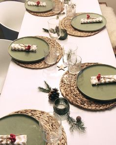 the table is set with place settings for christmas dinner