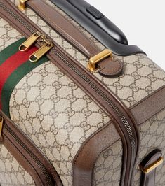 Find GUCCI Savoy Small Carry-on Suitcase on Editorialist. This Gucci Savoy suitcase is crafted from fabric and leather. It features a Gucci logo and a web stripe. This suitcase is designed to be carried on and has wheels for easy travel. It is made in Italy. Luxury Briefcase With Luggage Sleeve For Trip, Luxury Briefcase With Leather Trim For Travel, Luxury Travel Briefcase With Leather Trim, Luxury Leather Trim Briefcase For Travel, Designer Luggage With Sleeve For Trip, Designer Luggage With Sleeve For Travel, Designer Rectangular Travel Case, Luxury Briefcase With Leather Trim For Business Trips, Luxury Travel Cases