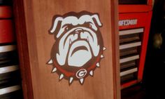 an image of a bulldog sticker on the side of a wooden cabinet in a room