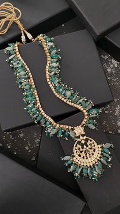 Green Kundan Inspired Necklace .This beautifully handcrafted necklace is set in silver and copper alloy and plated with 22k gold. This necklace with a twist of Pearl stones by Paisley Pop is a perfect accessory for an Indian Bride. Necklace Size - Length 36 inc, Width 1.5 inc Closure - Adjustable Thread Dori Style Tip - Wear this with almost anything Indian for a rich and royal look because nothing more regal than kundan necklace set. We love teaming this with classy chiffon sarees or zari silk Indian Bride Necklace, Green Beads Necklace, Royal Necklace, Rakhi Design, Green Beaded Necklace, Different Shades Of Green, Kundan Necklace, Green Beads, Necklace Green