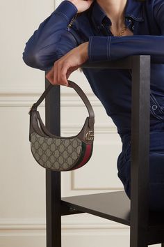 From the striped webbing and monogrammed canvas to the gold 'GG' hardware, this 'Ophidia' bag quite literally has Gucci written all over it. It's been crafted at the house's atelier in Italy and has an adjustable, belt-like shoulder strap. It unzips to reveal two handy card slots, as well as space for your phone and a few daily essentials. Gucci Ophidia Bag Outfit, Small Shoulder Bag Outfit, Mini Bag Outfit, Gucci Bag Outfit, Small Bags Fashion, Gucci Bags Handbags, Gucci Ophidia Bag, Mini Designer Bags, Gucci Ophidia