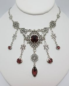 This is a new handmade necklace. It is made with antiqued silver plated filigrees, accented with high quality AMETHYST PURPLE glass jewels/rhinestones that sparkle like crystals. Decorated portion is 6 1/2" wide and 3 1/4" tall in the center. Necklace is adjustable 15-18" with a lobster clasp and chain extender. If you would like a different length, please send us a message.Matching earrings and headpiece are listed in our store. Antique Silver Necklace With Historical Design, Silver Necklaces With Historical Design For Wedding, Victorian Silver Necklace With Historical Design, Victorian Antique Silver Necklace With Intricate Design, Victorian Style Nickel-free Necklace For Weddings, Victorian Wedding Necklace Nickel-free, Victorian Wedding Necklace Nickel Free, Victorian Nickel-free Wedding Necklace, Victorian Style Nickel-free Wedding Necklace