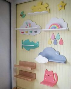 there is a wall decoration with clouds, stars and cats on the shelves above it