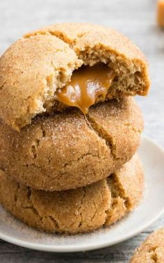 three cookies stacked on top of each other with caramel drizzle in the middle