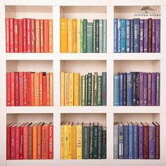 a book shelf filled with lots of colorful books on top of white shelves next to each other