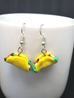 a pair of earrings made to look like two bananas