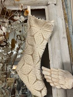 an angel's wing is hanging on the wall next to a christmas stocking