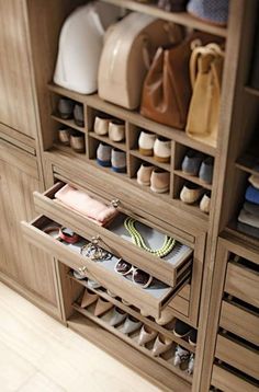 an organized closet with shoes, purses and handbags in it's drawers