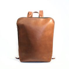 Tan Luxury Everyday Rectangular Backpack, Luxury Rectangular Leather Backpack For Daily Use, Luxury Rectangular Everyday Backpack, Modern On-the-go Standard Backpack, Modern Brown Leather Backpack For Daily Use, Everyday Rectangular Backpack With Leather Backing, Rectangular Everyday Backpack With Leather Backing, Rectangular Commuting Backpack With Leather Handles, Versatile Backpack With Leather Backing