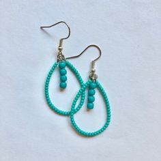 These handmade, beaded teardrop shaped earrings come in a variety of colors. this pair is A teal turquoise color. Perfect for all occasions and super comfortable to wear. These earrings are not heavy at all and can be worn comfortably all day. The earrings are 2 cm across. Every pair is unique and  may look somewhat different than the picture. I love making these earrings and hope you enjoy wearing them! Green Beaded Dangle Teardrop Earrings, Green Teardrop Earrings With Tiny Beads, Bohemian Turquoise Teardrop Drop Earrings, Turquoise Bohemian Teardrop Earrings, Colorful Beads Teardrop Earrings, Green Teardrop Beaded Earrings With Tiny Beads, Turquoise Teardrop Earrings With Tiny Beads, Turquoise Teardrop Beaded Earrings As Gift, Turquoise Teardrop Drop Earrings With Ear Wire