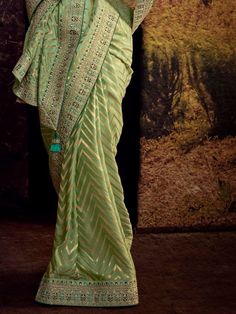 Create your occasional look more impressive by enrobing yourself in this stunning green Banglory silk party wear saree with a blouse. Crafted with precision and elegance, this saree is truly a masterpiece that will make you stand out at any event or party.
Firstly, it is made of high-quality Banglory silk fabric, ensuring a comfortable and luxurious feel against your skin. The stunning green color adds a touch of vibrancy and freshness to your overall look, making you the center of attention whe Festive Pista Green Banarasi Silk Pre-draped Saree, Festive Green Pre-draped Saree With Zari Weaving, Green Semi-stitched Pre-draped Saree With Meenakari, Green Dola Silk Pre-draped Saree For Diwali, Green Bollywood Pre-draped Saree With Meenakari, Green Pre-draped Saree With Zari Weaving For Diwali, Pista Green Banarasi Silk Pre-draped Saree For Eid, Green Chanderi Pre-draped Saree For Festivals, Green Pre-draped Saree With Self Design For Diwali