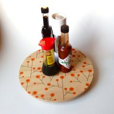 two bottles are sitting on a plate with sauces and condiments in them