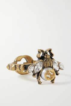 Gucci's bee emblem debuted in the '70s and is still a key house code today. This ring is carved from gold-tone metal in the shape of the insect and has crystal-embellished wings and a luminous faux pearl center. It's complete with an interlocking 'GG' logo at the back of the band. Gucci Ring Women, Ring Outfit, Key House, Gucci Bee, Gucci Ring, Horsebit Loafers, Bee Ring, Italian Luxury Brands, Faux Pearl Bracelet