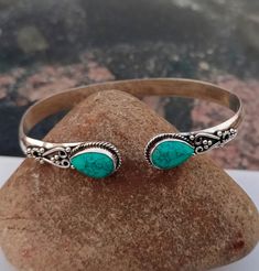 Turquoise Gemstone Bangle * 925 Sterling Silver *Handcraft Silver Bangle * Gift Item * Designer Bangle * Birthday Gift * Pear Shape Gemstone All my Designs are original. Stone - Turquoise Stone Shape - Pear Setting - Bezel This Bangle is for Women You will receive a Bangle like the one in the pictures This Bangle have 925 Stamp Suitable for use in everyday situations, or can also be used as a gift. Unique design will make a special attraction for the wearer. I make my jewelry with passion and love. The perfect gift for a Special occasion Wholesale Orders Accept on Wholesale Price All Pieces Have 925 Stamp Adjustable Turquoise Jewelry For May Birthstone, Bohemian Turquoise Sterling Silver Bracelet, Adjustable Turquoise Bracelet With Birthstone, Bohemian Stamped 925 Bracelet Gift, Turquoise Birthstone Bracelet, Handmade Green Sterling Silver Bangle, Southwestern Style Turquoise Bangle As A Gift, Handmade Turquoise Sterling Silver Bracelet Gift, Turquoise Sterling Silver Bracelet Gift