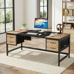 a desk with a computer on top of it in a room next to a window